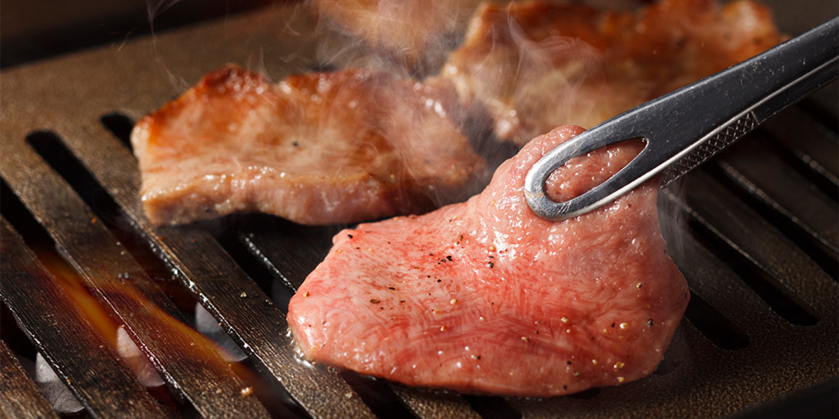 Savor the exquisite taste of authentic Kuroge Wagyu beef as it sizzles on the grill an unforgettable culinary experience awaiting every traveler in the heart of Tokyo.