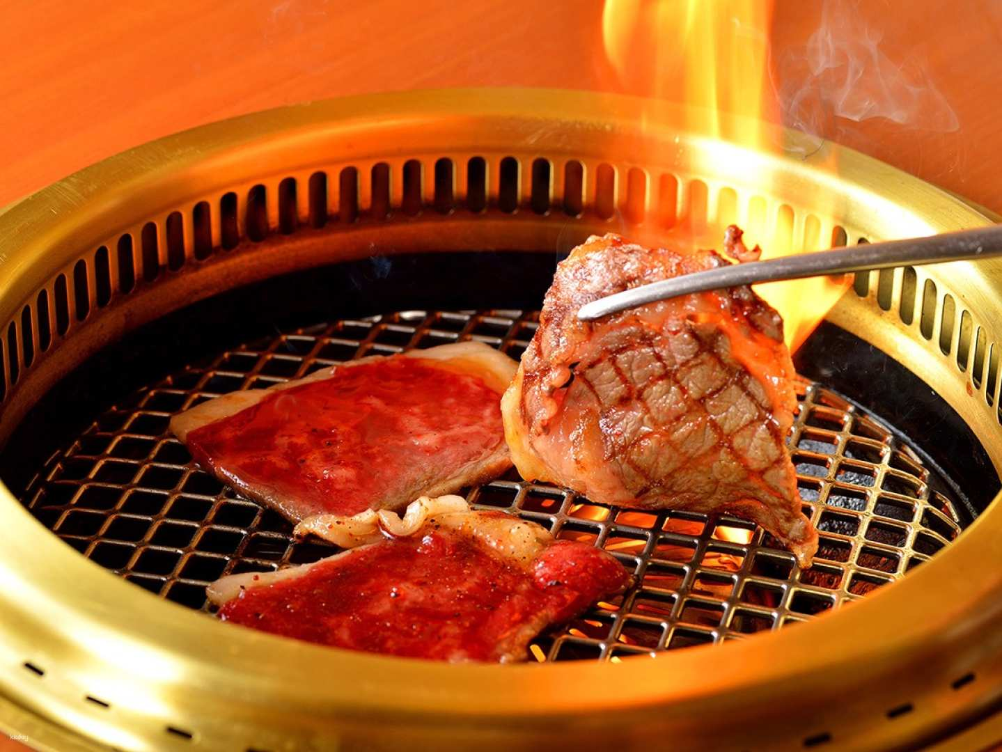 Savor the mouthwatering experience of grilling supreme Wagyu beef enhanced by Kyoto’s golden dipping sauce in a celebrated yakiniku restaurant that embodies culinary tradition since 1965.