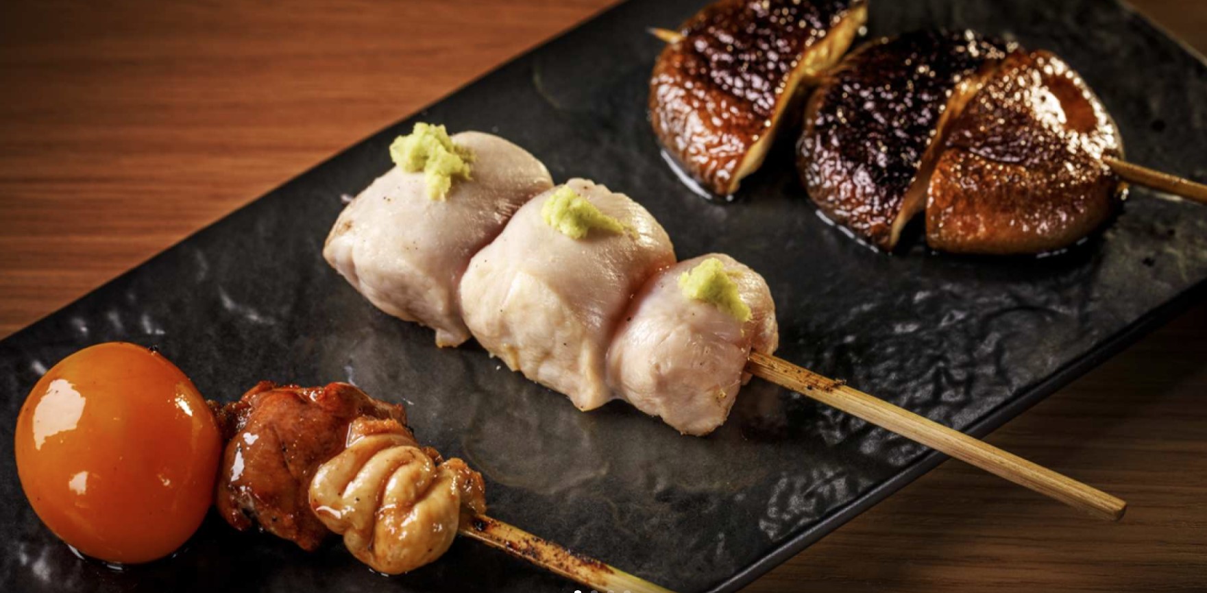 Savor expertly grilled yakitori skewers paired with fine sake and wine all while enjoying a stunning night view near Shinjuku Station. A true culinary adventure awaits.