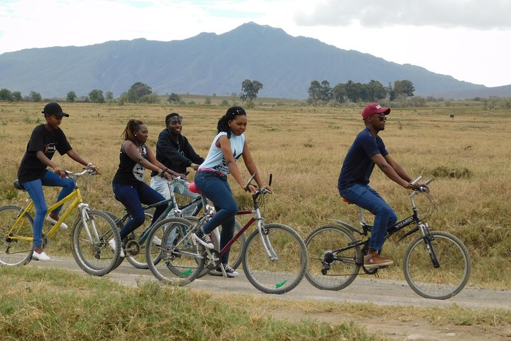 Cycling at Hellsgate National Park with Mt Longonot on the background