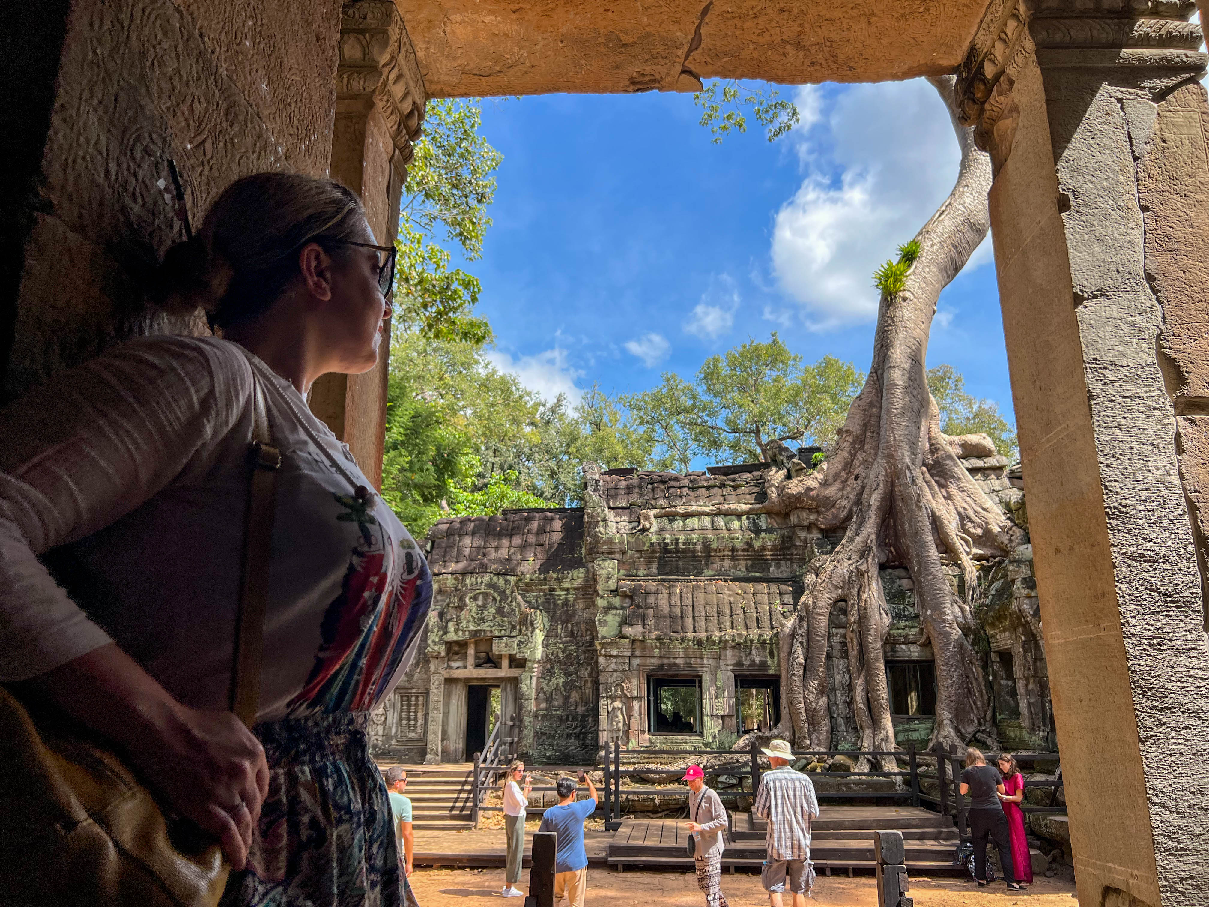 Experience the breathtaking fusion of nature and history at Angkor's iconic temples where ancient structures intertwine with lush greenery creating unforgettable moments at every turn.