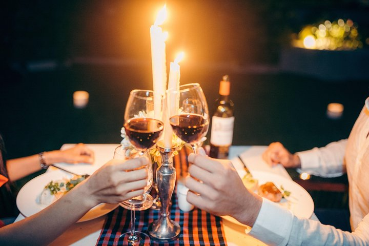 Indulge in a delightful meal with your partner as candles flicker and glasses clink creating memorable moments under a sky full of stars perfect for any romantic occasion.