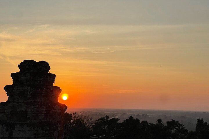 Gaze at the stunning sunset view from Phnom Bakheng Hill where ancient stones meet the colorful hues of twilight creating a perfect backdrop for unforgettable memories of Siem Reap.