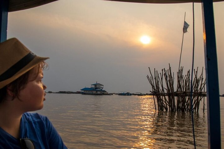 Experience the serene beauty of Tonle Sap Lake as the sun sets revealing the tranquil lifestyle of floating villages and the warmth of local smiles.