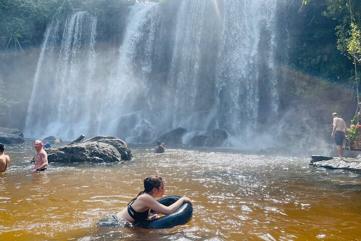 Experience the serene embrace of nature as you swim in the secluded waters beneath Phnom Kulen's majestic waterfalls surrounded by breathtaking scenery and rich cultural heritage.