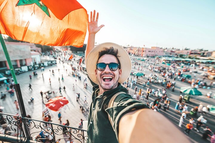 Happy tourist visiting Jamaa el-Fna market,