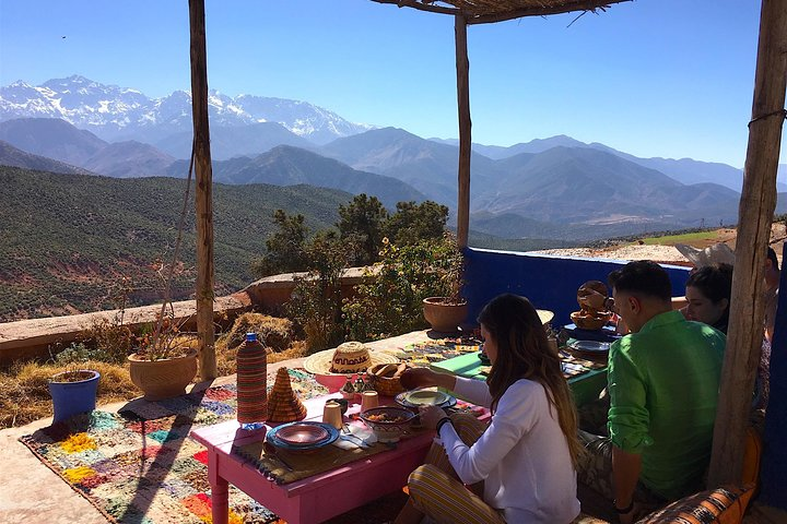 Homecooked lunch at the Berber family house with Atlas Mountains backdrop