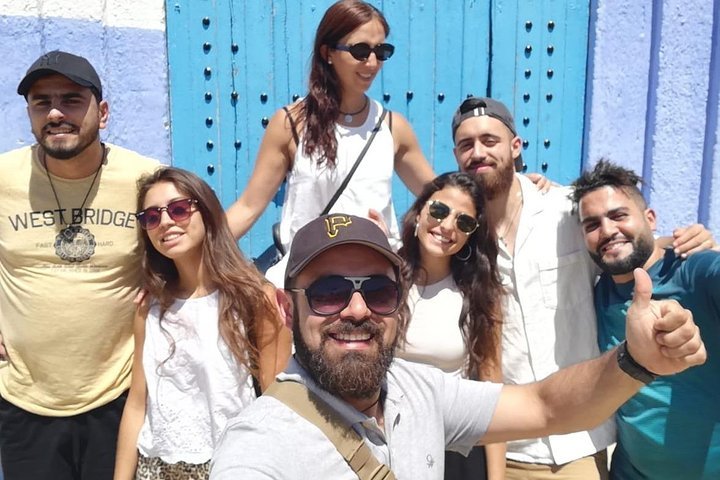 Sami with his clients behind them the th pricipal door signe of chefchaouen