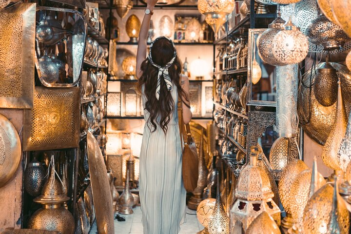 A girl shopping in a Moroccan lanterns shop in the Souk of Marrakech
