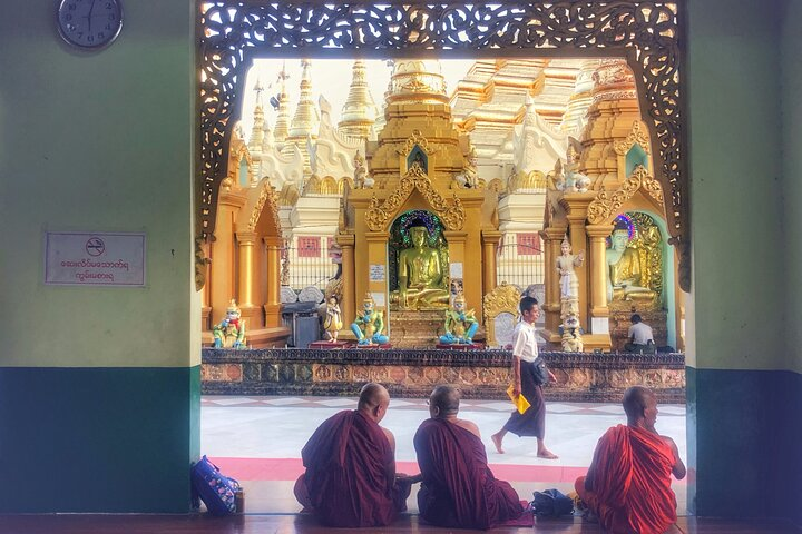 Buddhist monks chanting at Shwedagon Pagoda in Yangon .