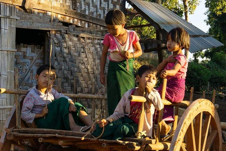 Kid's are playing on bull cart in the village .