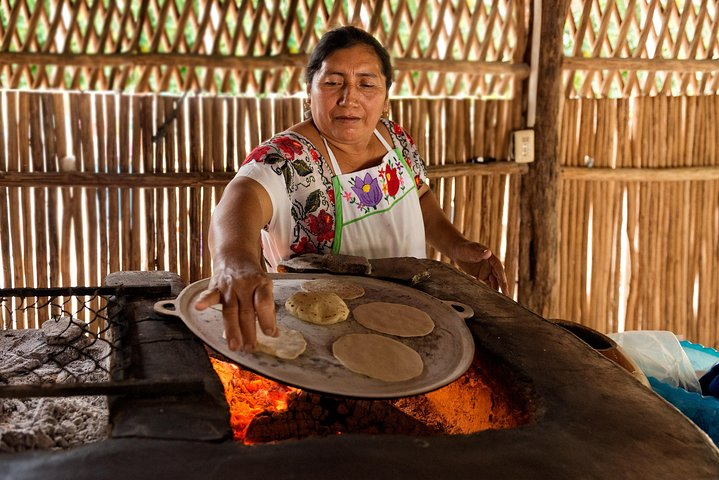 Typical Maya woman making tortillas