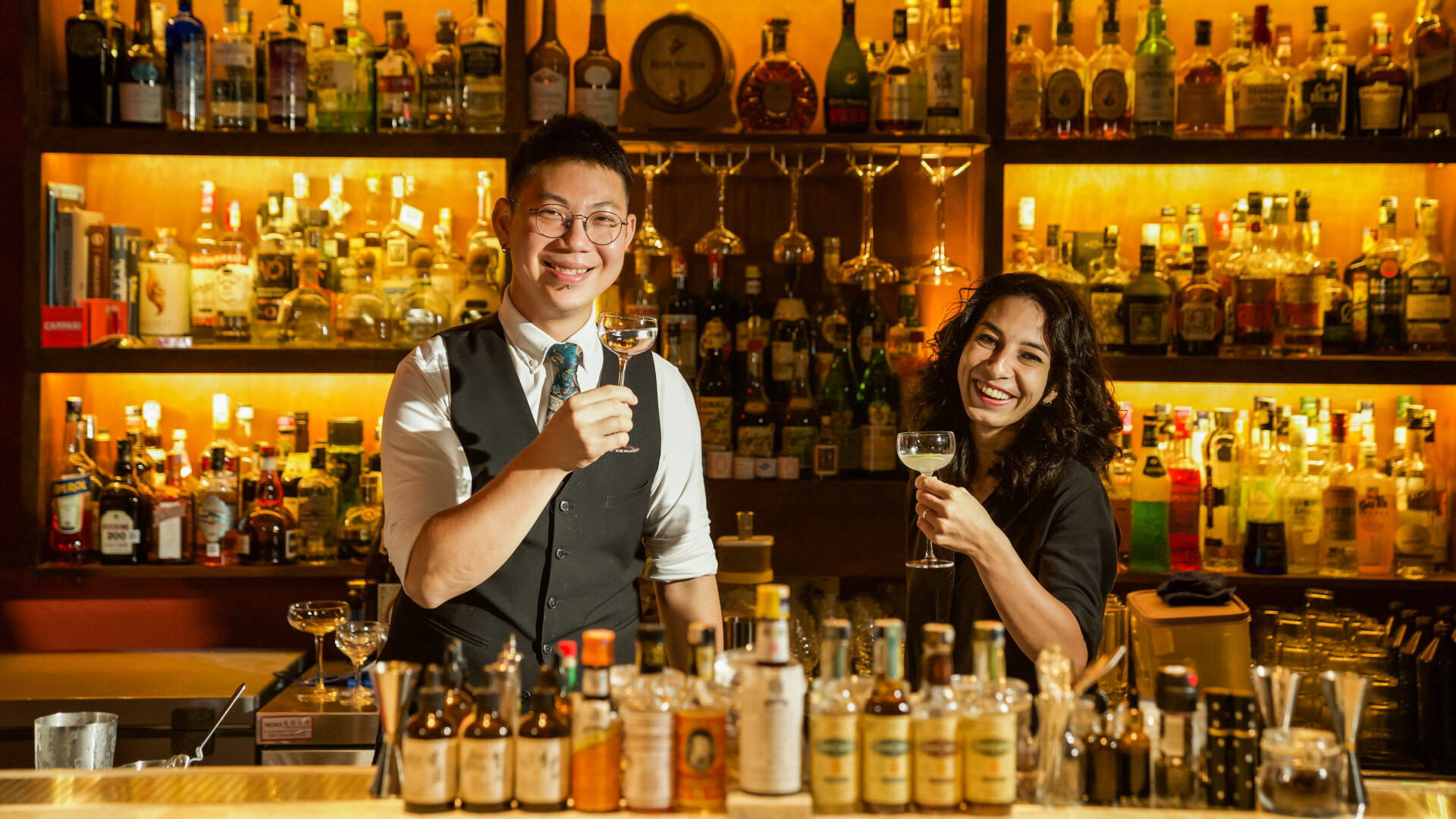 Discover the art of cocktail making in a hidden gem where skilled bartenders share their passion. Enjoy hands-on experience mixing classic highballs sours and old fashioneds among an impressive selection of spirits.