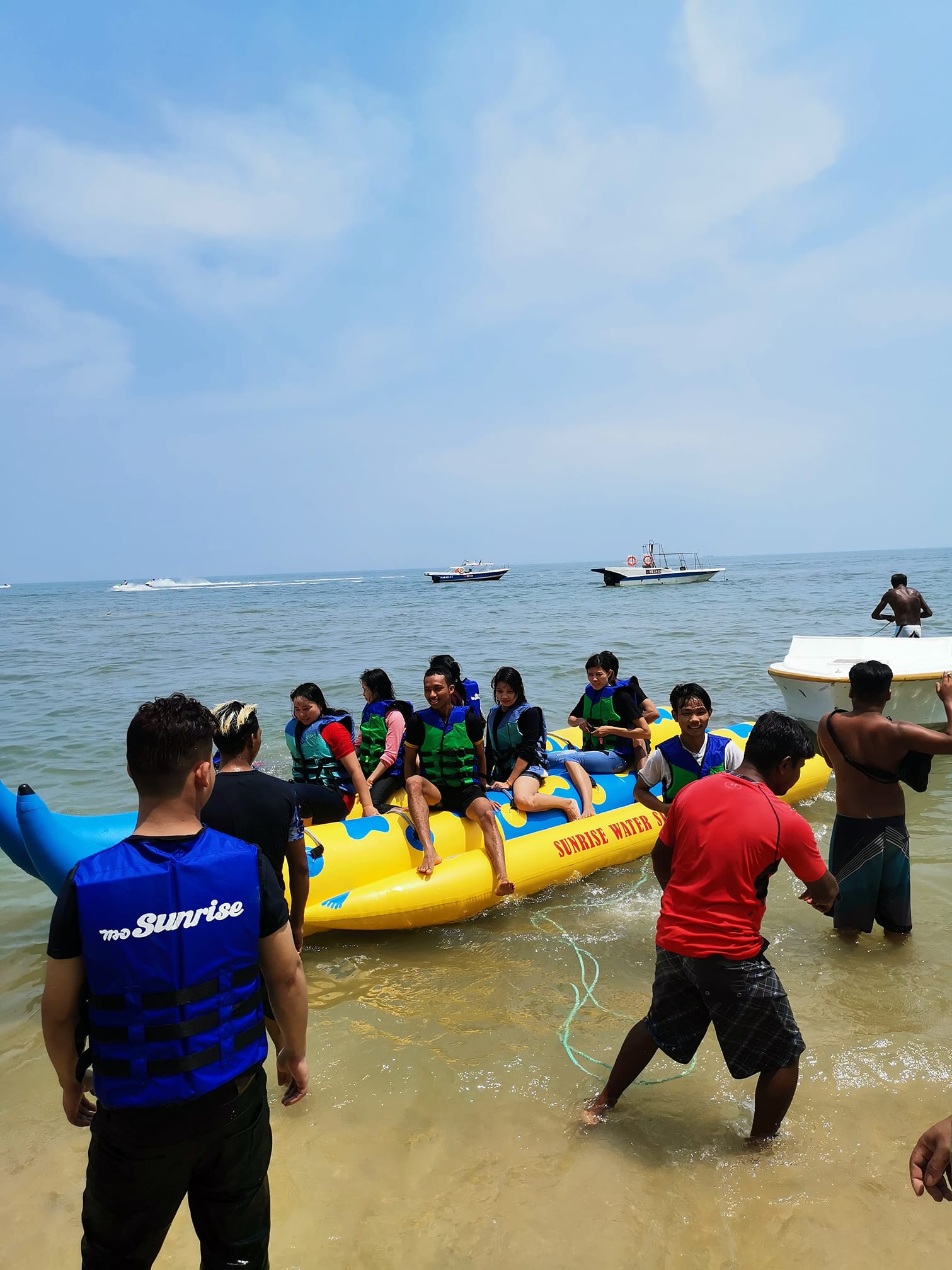 Experience the excitement of a banana boat ride at Batu Ferringhi surrounded by stunning coastal views and the laughter of friends and family making unforgettable beach memories.