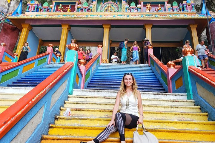 Taking photo by the Batu Caves temple colourful staircase
