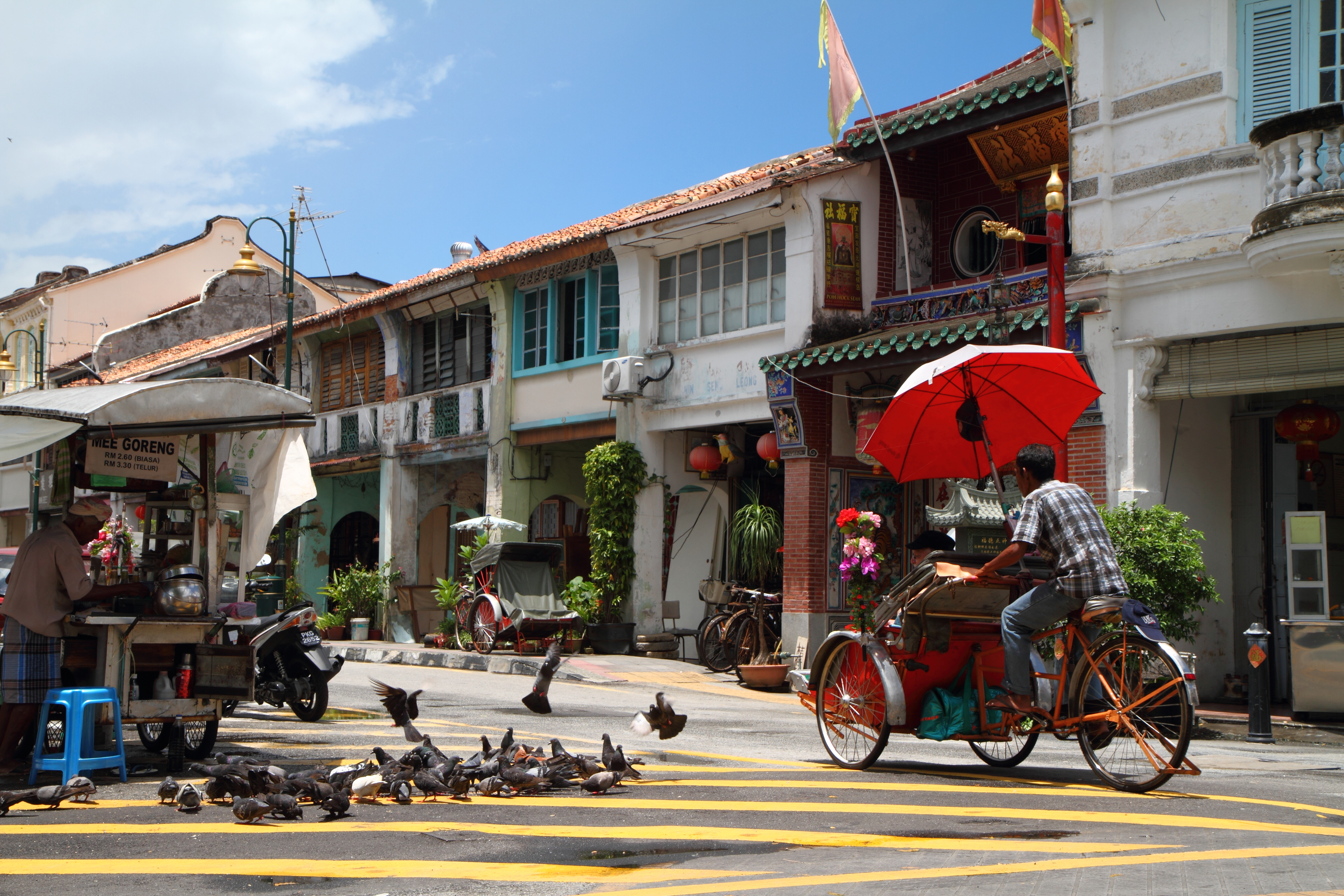 Explore the charm of Georgetown on a trishaw ride weaving through lively streets and historic sites while discovering the rich tapestry of cultures and architecture that define Penang.