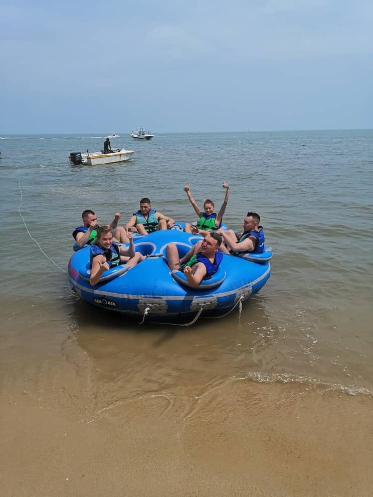 Experience the excitement of Batu Ferringhi's coastline as you ride the waves on a donut boat surrounded by friends and the refreshing sea breeze. Fun awaits!