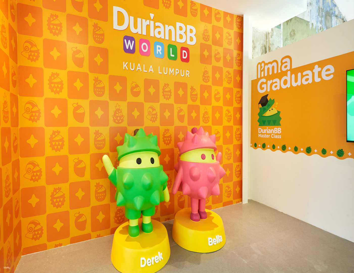Discover the delight of durian with playful mascots welcoming you to a unique tasting experience showcasing a selection of iconic Musang King desserts and beverages in Kuala Lumpur’s vibrant setting.