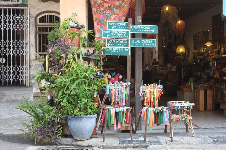 Explore the charming streets of Penang where colorful signposts guide you to hidden gems and local shops brim with unique finds. A perfect blend of culture and adventure awaits!
