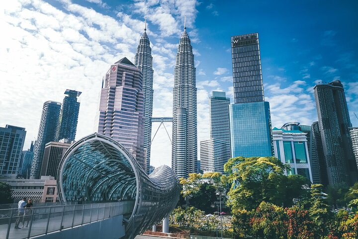 Explore Kuala Lumpur's iconic skyline featuring the Petronas Twin Towers and the stunning Saloma Bridge. Experience cultural richness historical landmarks and unforgettable sights in a leisurely private tour.