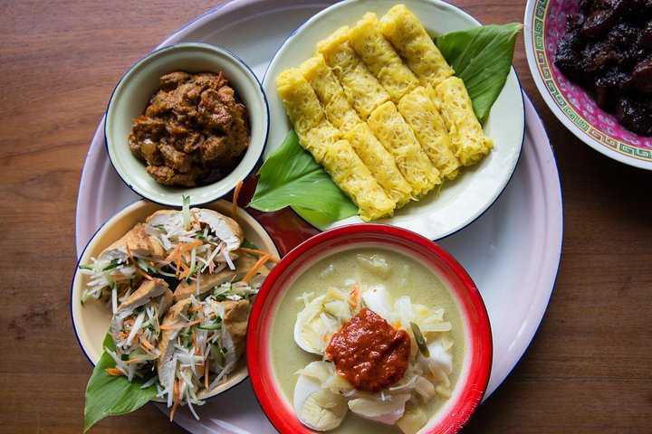 Savor the rich flavors of a home-cooked Peranakan meal in a cozy setting where vibrant ingredients and shared stories create lasting connections over a delicious culinary experience.