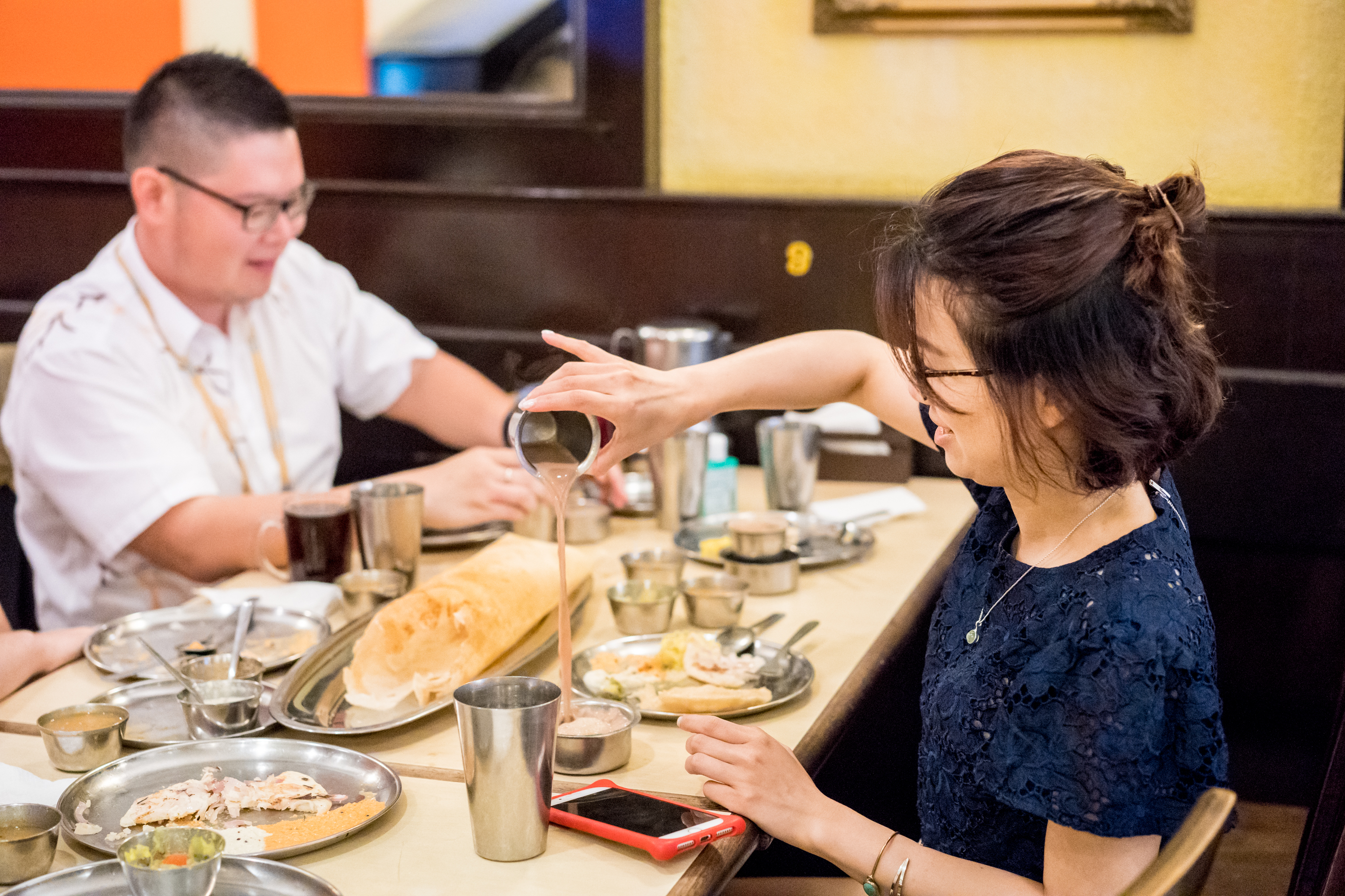 Experience the joy of sharing local delicacies like roti Chennai and savoring Penang's rich heritage and culture while enjoying a meal with friends surrounded by historic charm.
