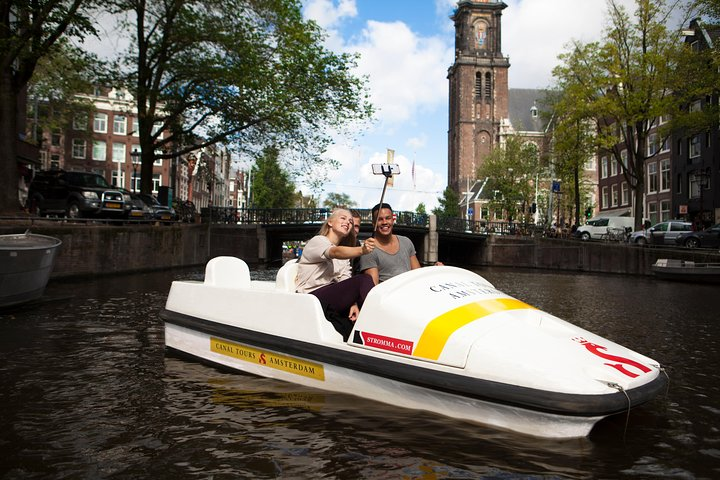 Pedal through Amsterdam’s charming canals enjoying unique views of historic sites like the Anne Frank House and Rijksmuseum while creating unforgettable memories with friends.