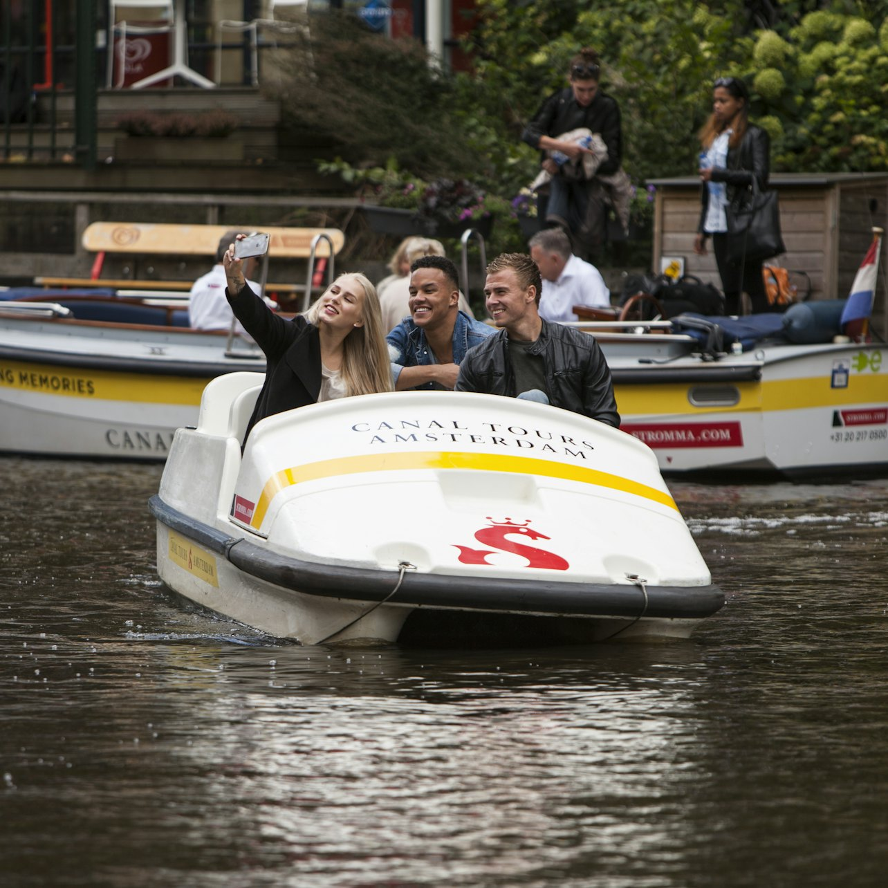 Glide through Amsterdam's scenic canals on a pedal boat enjoying unique views and creating unforgettable memories with family and friends amidst the city's charming waterways.