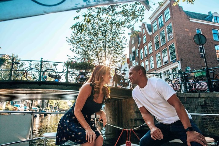 Drift through Amsterdam’s serene canals sharing intimate moments under charming bridges and 17th-century houses while listening to stories and music that deepen your connection.