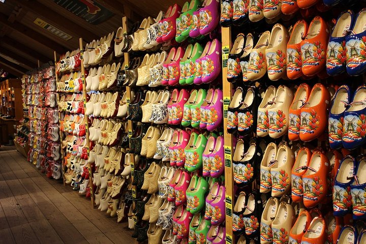 Experience the charm of traditional wooden shoe making surrounded by a dazzling array of handcrafted clogs each telling a unique story of Dutch culture and craftsmanship.