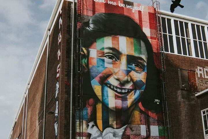 Explore the streets of Amsterdam while learning about Anne Frank's life surrounded by historical sights and vibrant murals that bring her story to life in an engaging way.