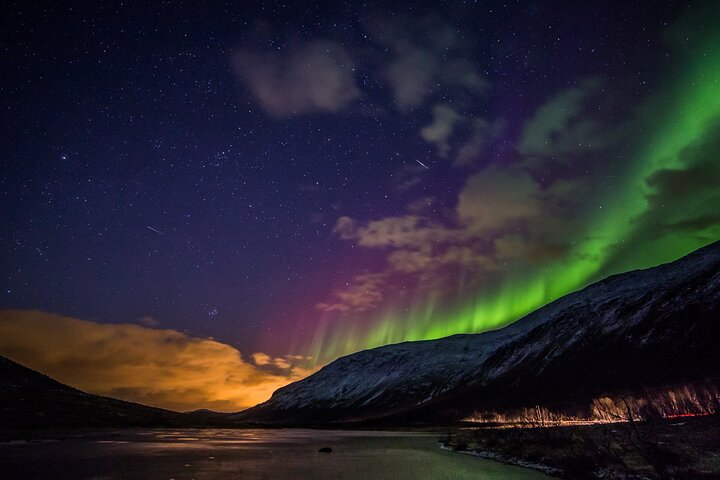 Experience the stunning dance of the Northern Lights illuminating the Arctic landscape surrounded by pristine nature and serene beauty. A magical escape awaits under the polar sky.