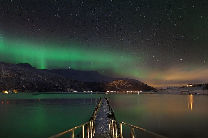 Experience the wonder of the Northern Lights in Tromsø surrounded by stunning landscapes as you embark on a memorable private tour with personalized guidance and cozy comforts.