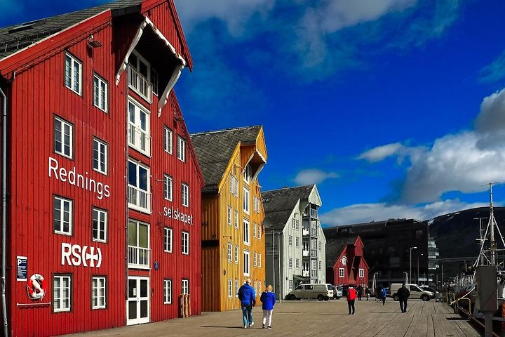 Explore the charming waterfront of Tromsø where colorful architecture meets breathtaking natural beauty. Experience rich history and culture as you stroll among iconic landmarks and local attractions.