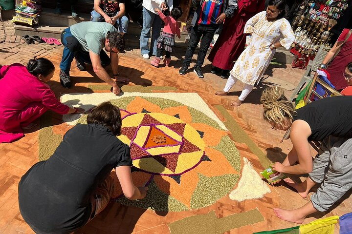tourists making a mandala using different type of grains
