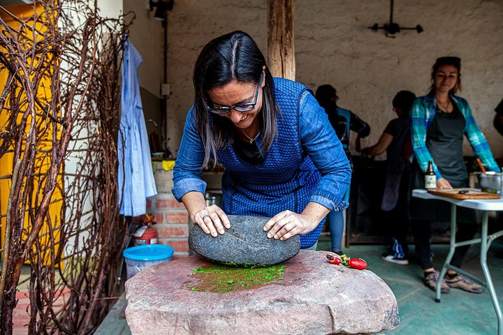 Making "ají", a chili sauce using the "batan", ancient grinder made of stone