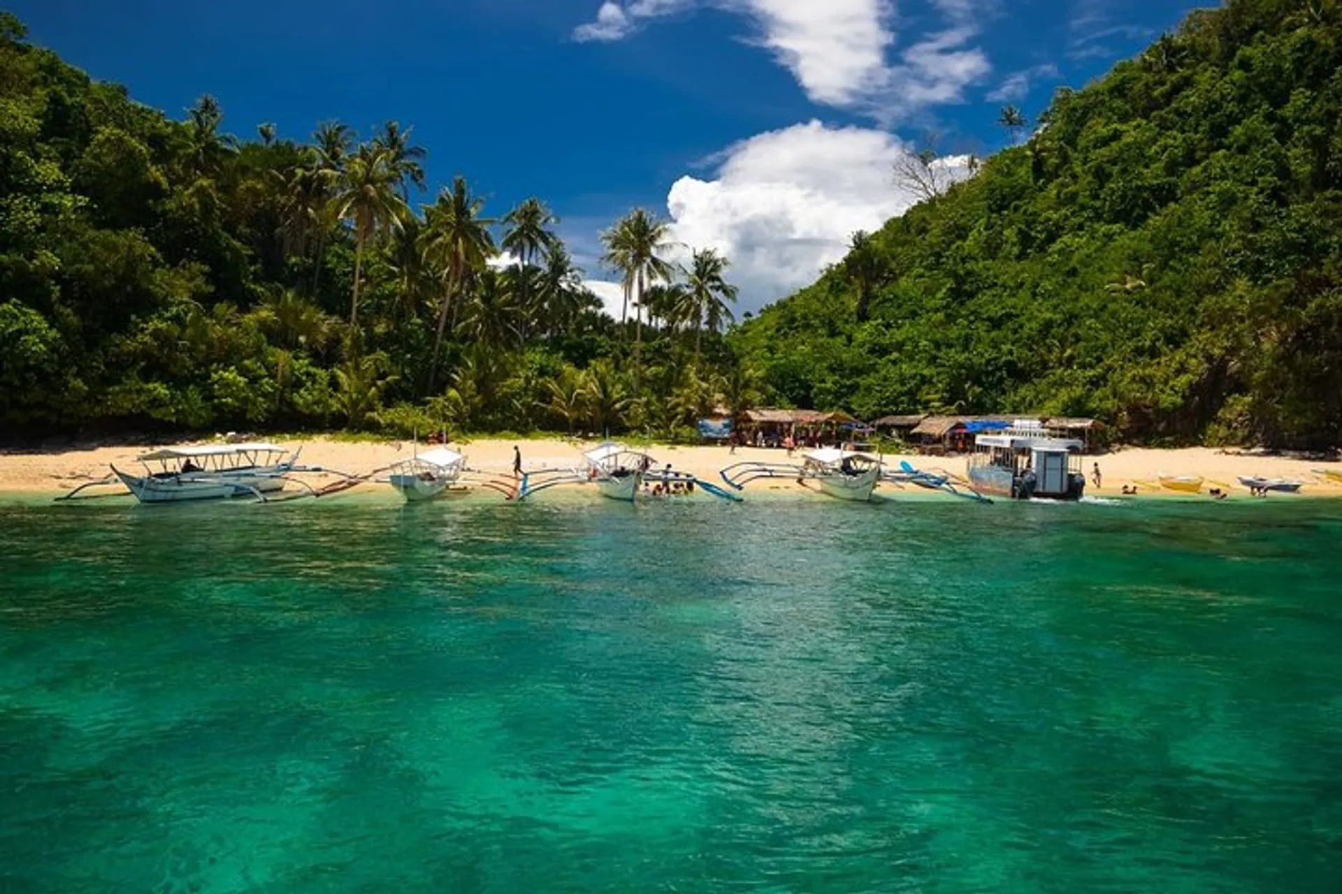 Puerto Galera island hopping beach and outrigger boats