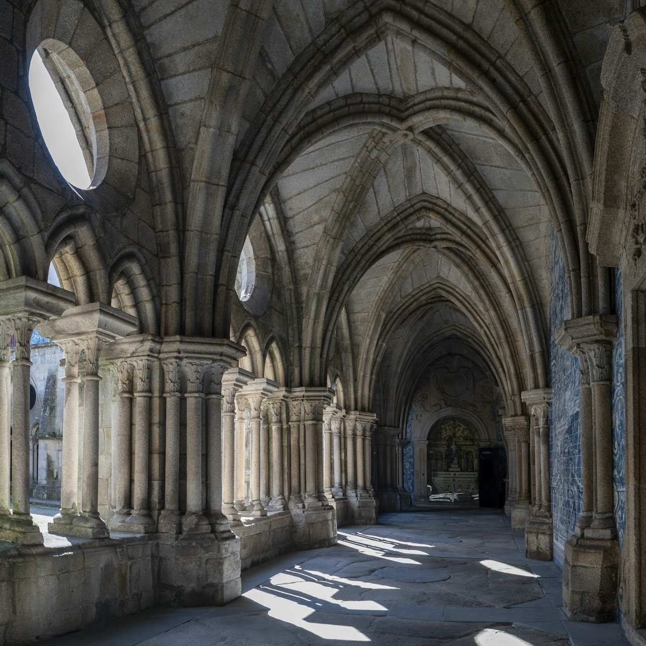Explore the stunning architecture and intricate details of the Cathedral of Porto's cloisters where light plays beautifully against ancient stone inviting reflection and wonder at every turn.