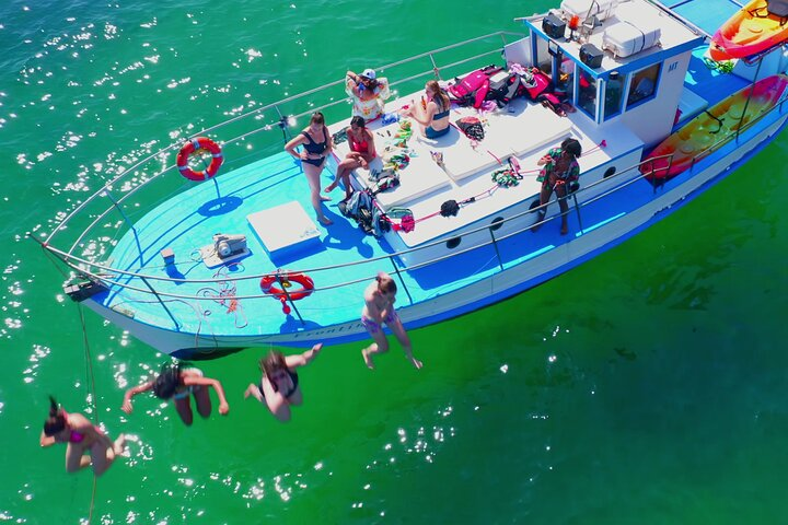 Making a splash! ️ Jumping into fun from our classic 1957 wooden boat.