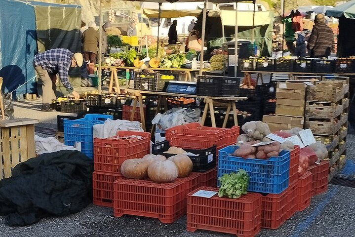 Experience the charm of a bustling local farmers market where fresh produce and artisanal crafts create a lively backdrop offering a taste of Portugal's countryside lifestyle.