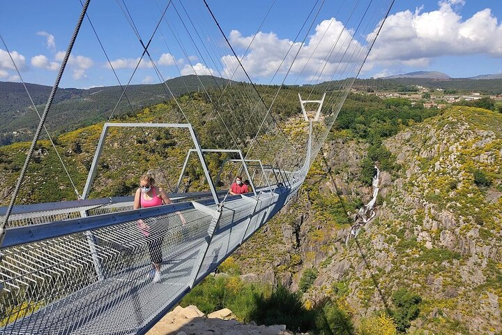 Experience the breathtaking views from one of the world's longest suspension bridges connecting lush valleys and the serene Paiva river on an unforgettable journey through Arouca's stunning landscapes.