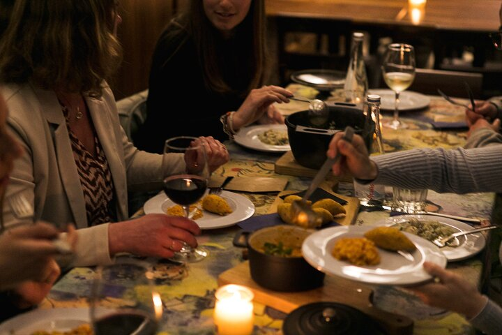 Savor the authentic tastes of Porto as you share delightful dishes with newfound friends exploring the city's culinary gems in a warm and inviting setting.