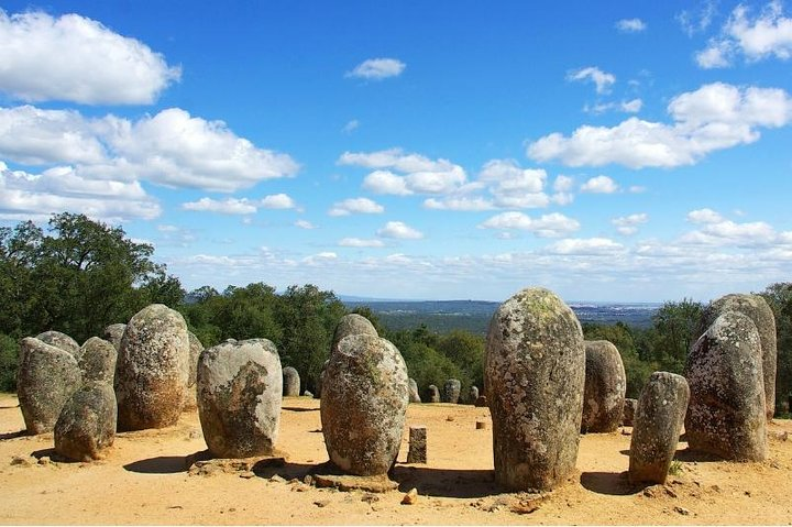 Discover the ancient mystery of Almendres Cromlech where towering stones tell stories of the past against a backdrop of rolling hills and open skies perfect for adventurous explorers.