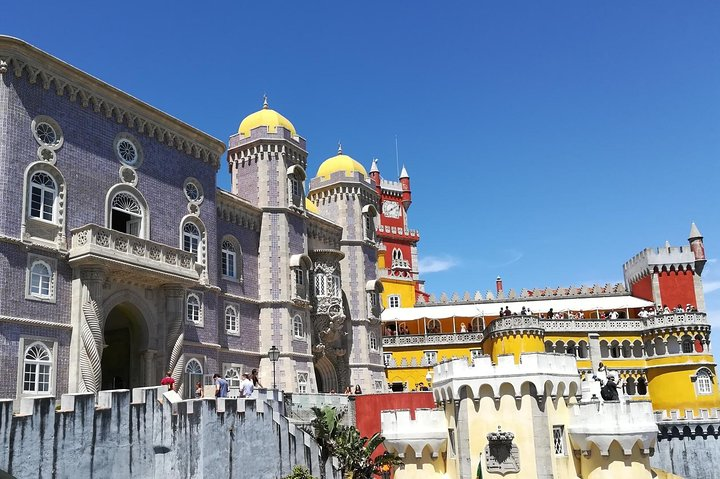 Explore the stunning architecture of Pena Palace a highlight of the private tour through Sintra Cabo da Roca and Cascais revealing the region's rich history and scenic beauty.
