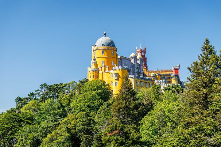 Standing on top of a hill, Sintra’s most spectacular site is the colorful painted and ornate Pena Palace (Palácio da Pena), a must-have on every travel bucket list.