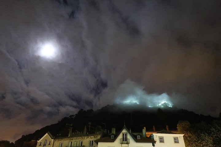 A view from the meeting point in the Historic Centre: the full moon and the fog covering Sintra's Castle.