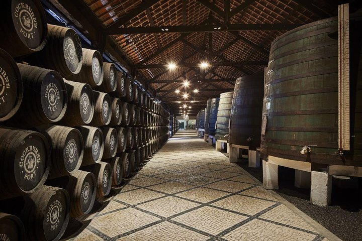 Explore the extensive aging warehouse at Cockburn's where Port wines develop their unique character in oak casks surrounded by history and the craft of skilled coopers.