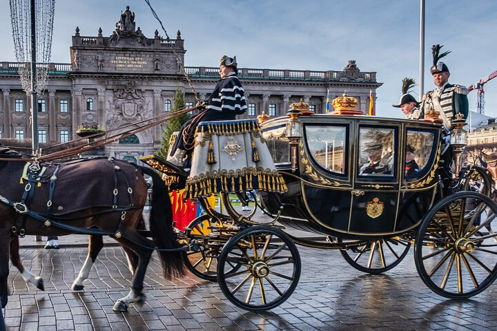 Experience the elegance of royal tradition as horse-drawn carriages glide gracefully past the magnificent Stockholm Royal Palace a stunning testament to Sweden's rich history and culture.