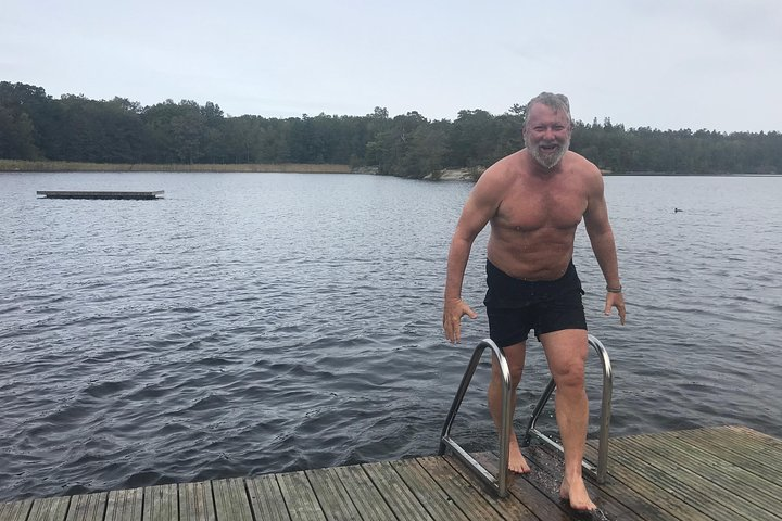 Experience a unique blend of Swedish tradition as you take a brisk dip in the refreshing lake embracing the adventurous spirit of the Fire and Ice Tour in Stockholm.