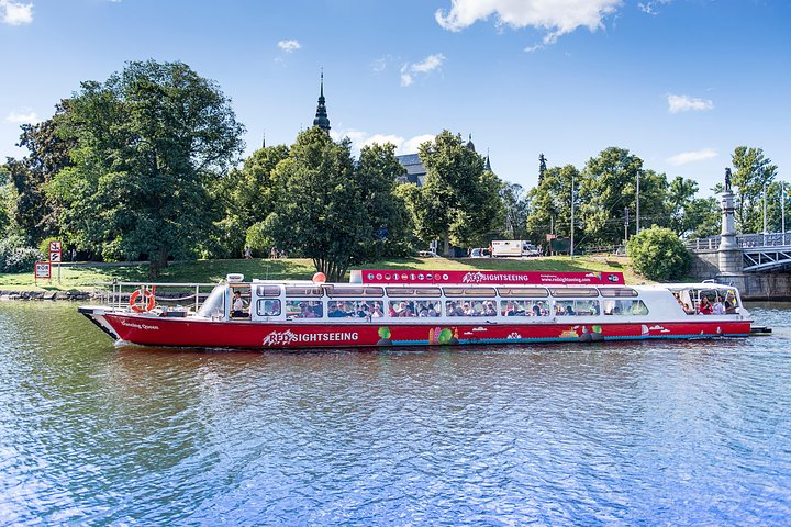 Glide through Stockholm's picturesque waterways on a scenic cruise exploring the beauty of The Royal Island of Djurgården while soaking in the unique architecture and lush surroundings.
